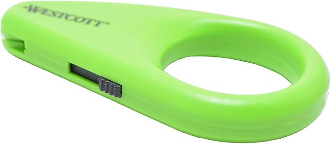 Westcott Mini Ceramic Safety Blade Box Opener in green, featuring a compact design with a ceramic blade. The opener is shown against a neutral background, highlighting its ergonomic shape and safety features for cutting PVC tape.