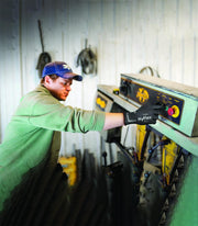 Ansell HyFlex 11-840 gloves worn by a worker handling materials in an industrial environment.
