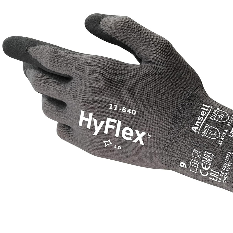Worker wearing Ansell HyFlex 11-840 gloves while adjusting machinery components