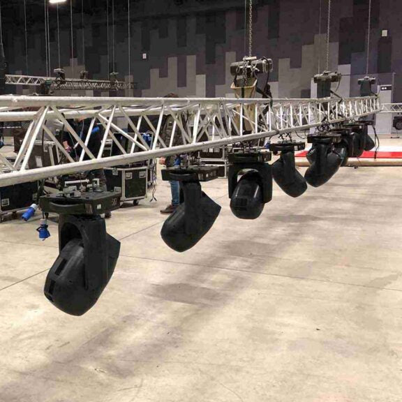 Magnetic Mini Spirit Level placed on truss-mounted moving light for accurate leveling.
