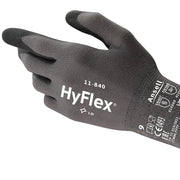 Worker wearing Ansell HyFlex 11-840 gloves while adjusting machinery components