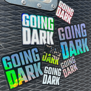 A flightcase featuring the Going Dark Special Edition 7-Piece Sticker Set. The set includes a variety of unique finishes, featuring holographic, mirror, and glitter designs that catch the light in all the right ways, creating a dynamic, eye-catching effect. The stickers are displayed on the lid of the flightcase, with bold, edgy graphics, including abstract patterns, logos, and stylised text, adding a custom, artistic flair.
