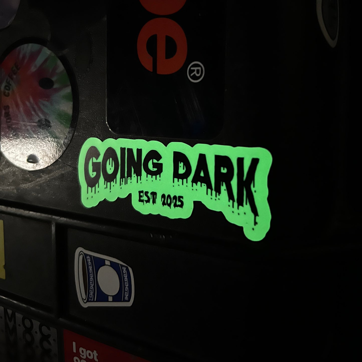 Glowing green 'GOING DARK' sticker on a dark background with visible branding.