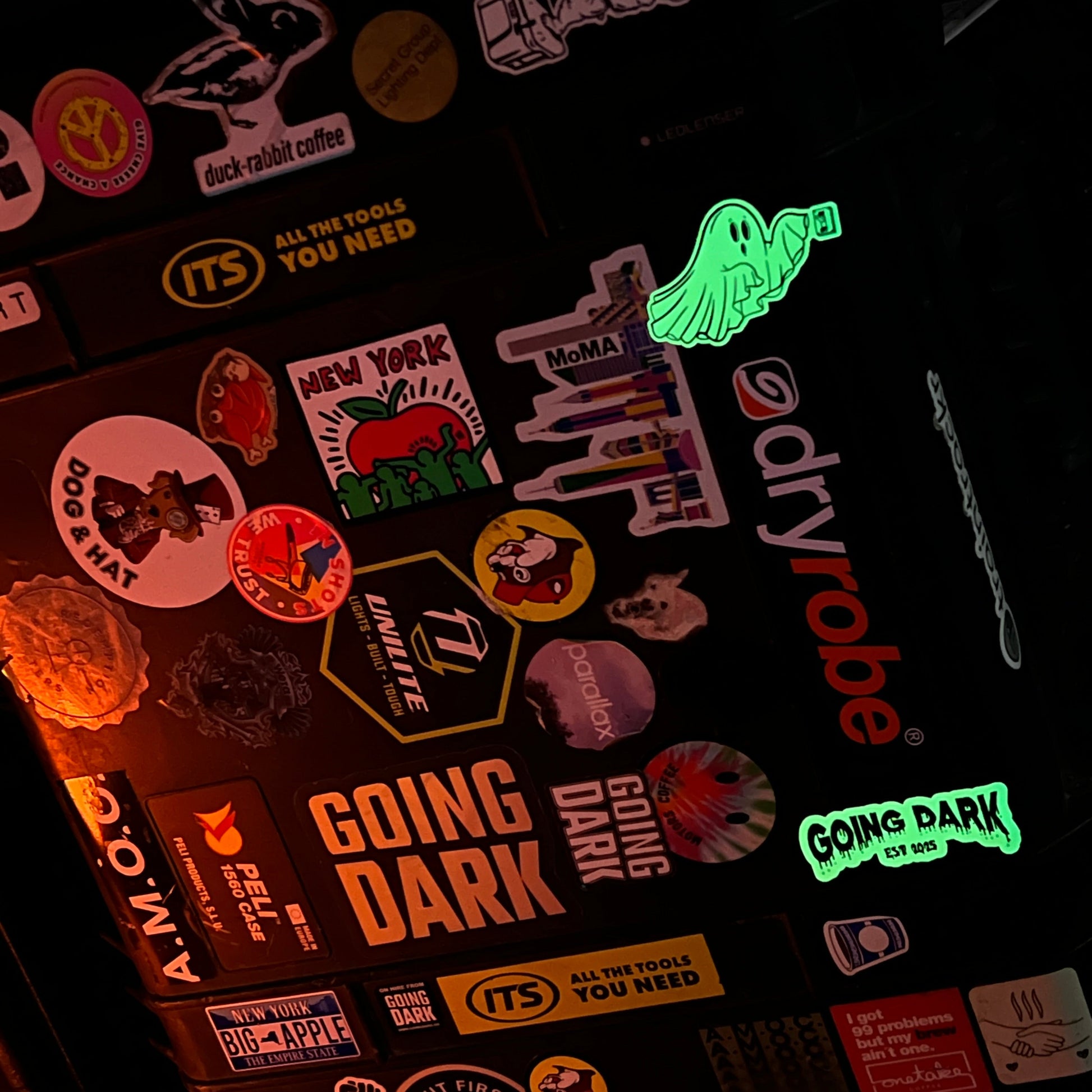 Collection of stickers on a dark surface with 'Dryrobe' brand visible