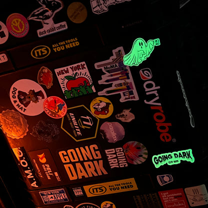 Collection of stickers on a dark surface with 'Dryrobe' brand visible